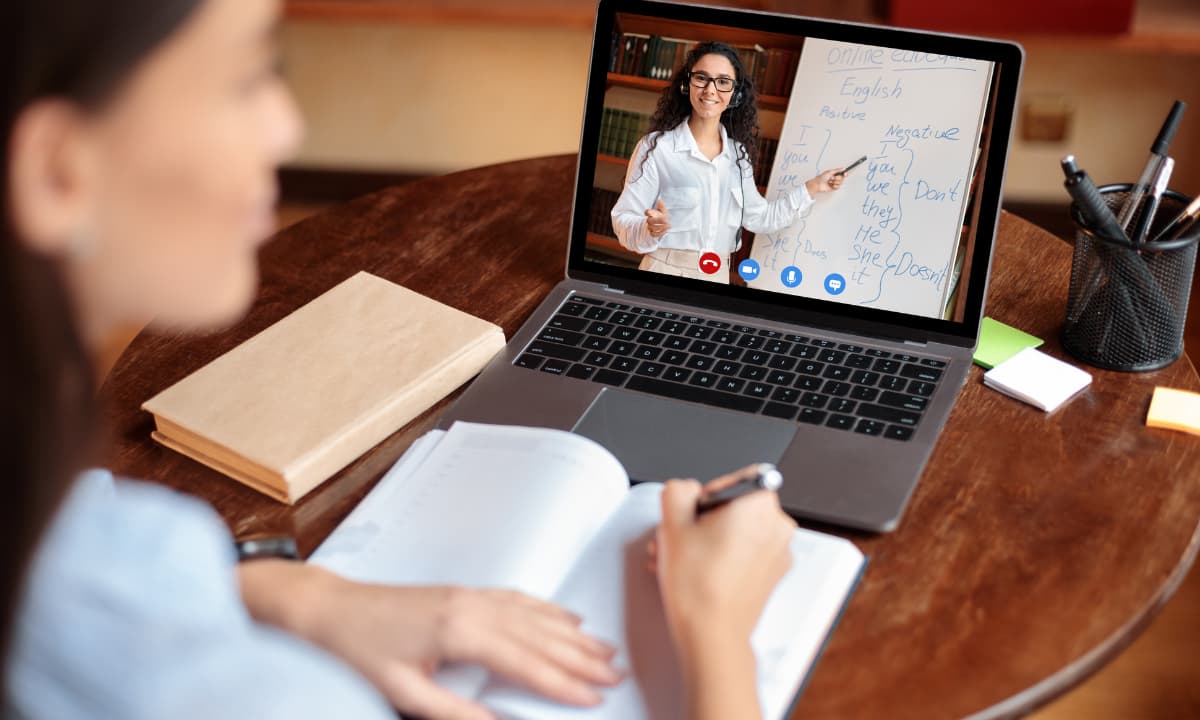 A learner following a video lesson on a laptop