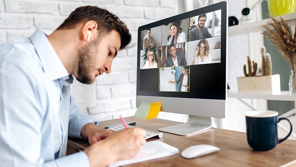 A learner taking notes during a live online session